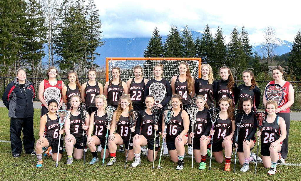 The Mount Si High School girls lacrosse team includes, from left: kneeling - Misa Kalvelage, Alyssa Martin, Molly Wyrsch, Kami Smith, Emily Blankenburg, Jessica Morris, Gracee Gorrell, Izzy Alati, Sydney Gabel, and Lauren Duvall; and standing - Coach Christy Clinton, Esther Litwack-Lang, Gabi Krueger, Keira Mix, Karly Barlow, Riordan Roche, Tessa Lewis, Sam Smith, Maia Rezoski, Lily Nordby, Jackie Stone, and Chianne Gudaitis.