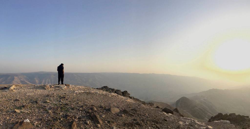 Jawad Abu Rumman, a guide at Experience Jordan, looks across a canyon as the group prepares to set up up camp on the second day of their journey across Jordan. (Courtesy Photo)