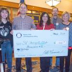 Members of the Snoqualmie Valley Unicycle Club were awarded a grant Thursday. Pictured from left are club members Grace Luccio, Paul Luccio, Laura Gutenberg, Rotary President Jeff Mumma and Rotarian Nancy Whitaker.