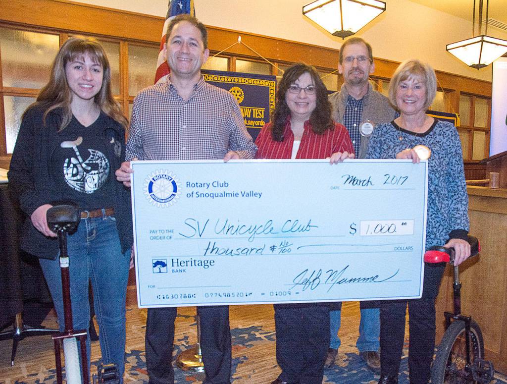 Members of the Snoqualmie Valley Unicycle Club were awarded a grant Thursday. Pictured from left are club members Grace Luccio, Paul Luccio, Laura Gutenberg, Rotary President Jeff Mumma and Rotarian Nancy Whitaker.