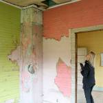 Minna Rudd, recreation manager for Si View Metropolitan Park District, walks through the interior of the Tollgate Farmhouse. An interior renovation is one of the big projects the district is pursuing. (Evan Pappas/Staff Photo)