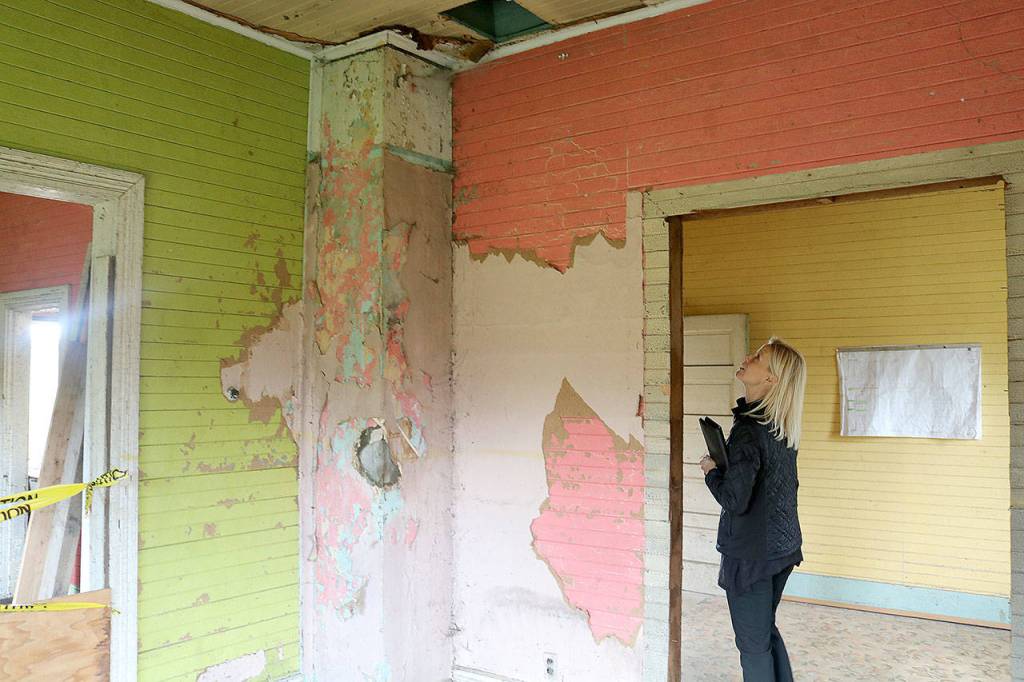 Minna Rudd, recreation manager for Si View Metropolitan Park District, walks through the interior of the Tollgate Farmhouse. An interior renovation is one of the big projects the district is pursuing. (Evan Pappas/Staff Photo)