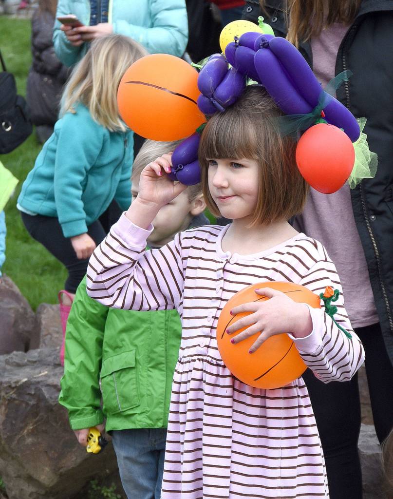 Colorful balloons gave this parade marcher a Carmen-Miranda-style hat.                                Carol Ladwig/Staff Photo