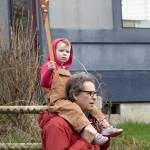 A young boy rides on his father&rsquo;s shoulders for the March of the Vegetables.                                Carol Ladwig/Staff Photo