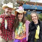 Dressed as farmers, flowers, vegetables and pollinators, Doug Klaiber, Beth Burris and Clare Chapple enjoyed the March of the Vegetables.                                Carol Ladwig/Staff Photo