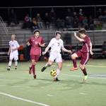Andy Kirby faces off against two Eastlake players as he gets into position to pass. (Photo courtesy of Calder Productions)
