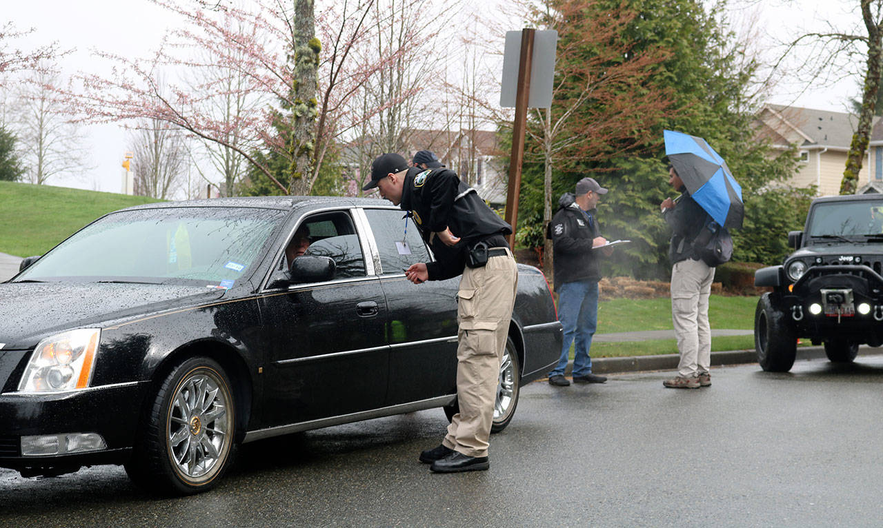 Snoqualmie Police Officer Chad Ridout questions a community volunteer, who was playing the role of a registered sex offender during a child abduction training exercise last Thursday on Snoqualmie Ridge. During the exercise, police investigated this suspect but found he was not the culprit. (Evan Pappas/Staff Photo)
