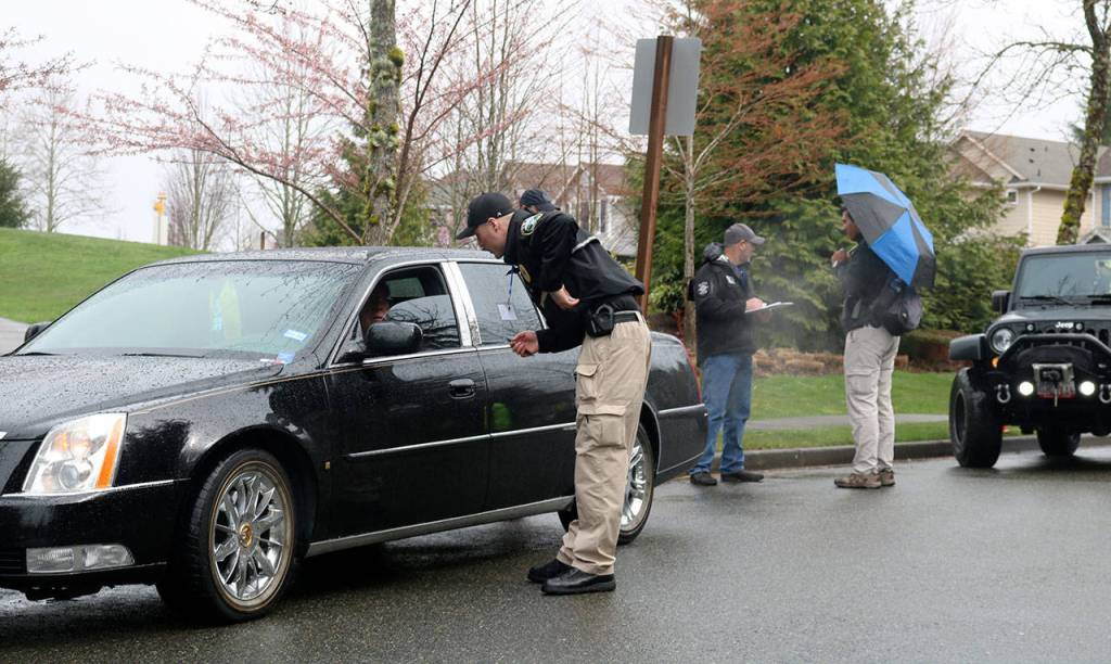 Snoqualmie Police Officer Chad Ridout questions a community volunteer, who was playing the role of a registered sex offender during a child abduction training exercise last Thursday on Snoqualmie Ridge. During the exercise, police investigated this suspect but found he was not the culprit. (Evan Pappas/Staff Photo)