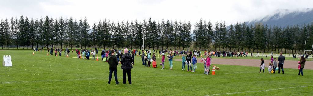 Children and parents line the fields at Centennial Fields Park Saturday morning before the start of the annual egg hunt. Carol Ladwig/Staff Photo