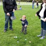Carter Coleman, 19 months, was more interested in picking up eggs at Snoqualmie&rsquo;s hunt Saturday morning at Centennial Field, than he was in find out what was inside them. His parents, Tim and Angela Coleman obliged by tossing eggs from his basket back onto the grass for him to collect again and again. Carol Ladwig/Staff Photo
