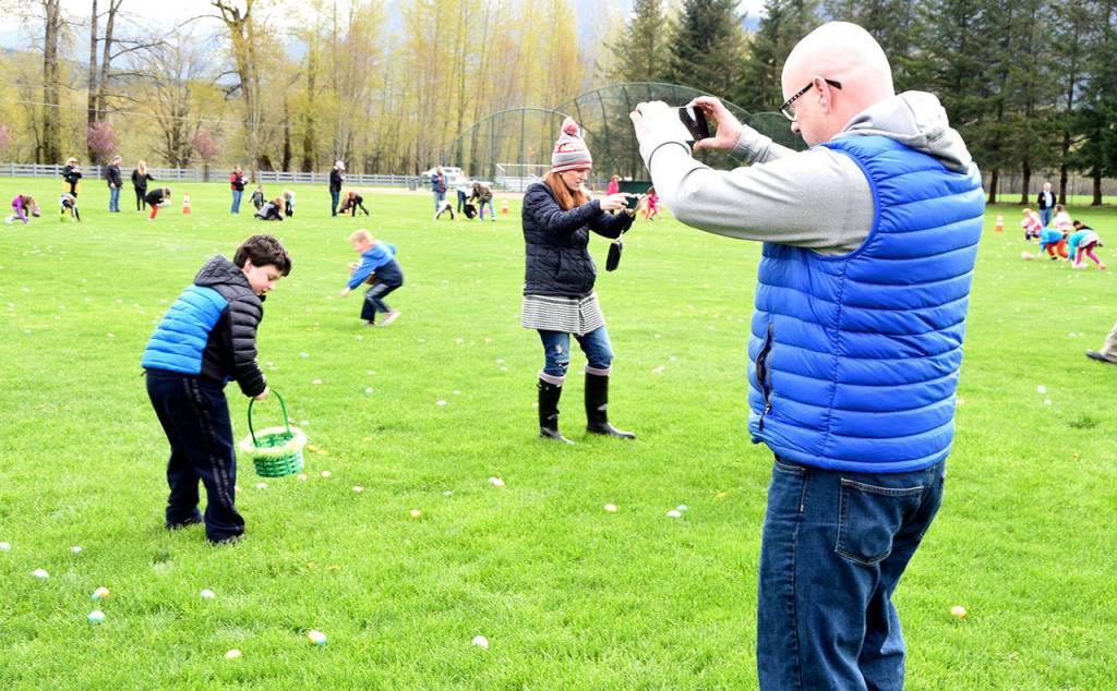 Rob Hinkle captures every minute of his son, Danny&rsquo;s exploits at Snoqualmie&rsquo;s egg hunt at Centennial Fields Saturday. Carol Ladwig/Staff Photo
