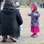 Sophie Nguyen, age 2, hops in excitement as she waits for her father, Lam, to reveal the prizes inside the eggs she collected Saturday. Carol Ladwig/Staff Photo