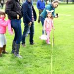 Lining up before the egg hunt, Maria and mom, Claudia Castle, and Sean Scott, his daughter Maia, and her grandparents Mark and Rosalie Aiken discuss egg-hunting strategies. Carol Ladwig/Staff Photo