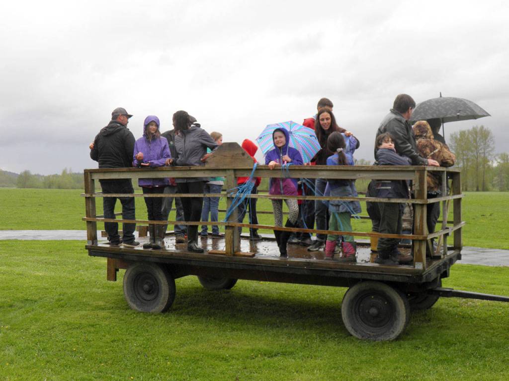 Despite the rain, families get into the basket in preparation for an afternoon hayride around Meadowbrook Farm. (Courtesy Photo)