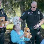 Officers and residents have a little fun with the teddy bears on Friday morning. (Photo courtesy of NW Gypsy Photography)