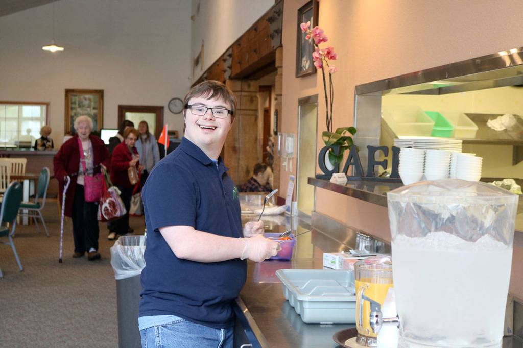 TLC student Silas works at the Mount Si Senior Center, helping the kitchen staff with setting the tables and various other activities.                                (Evan Pappas/Staff Photo)
