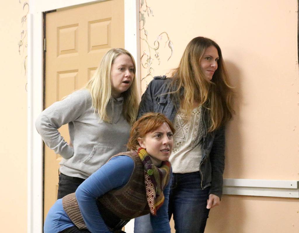 Three bridesmaids look out a window at the wedding reception below. From left: Natalie Collions playing Frances, Rachel Wilkie playing Meredith, and Penny McMillan-Hughes playing Trisha.                                (Evan Pappas/Staff Photos)