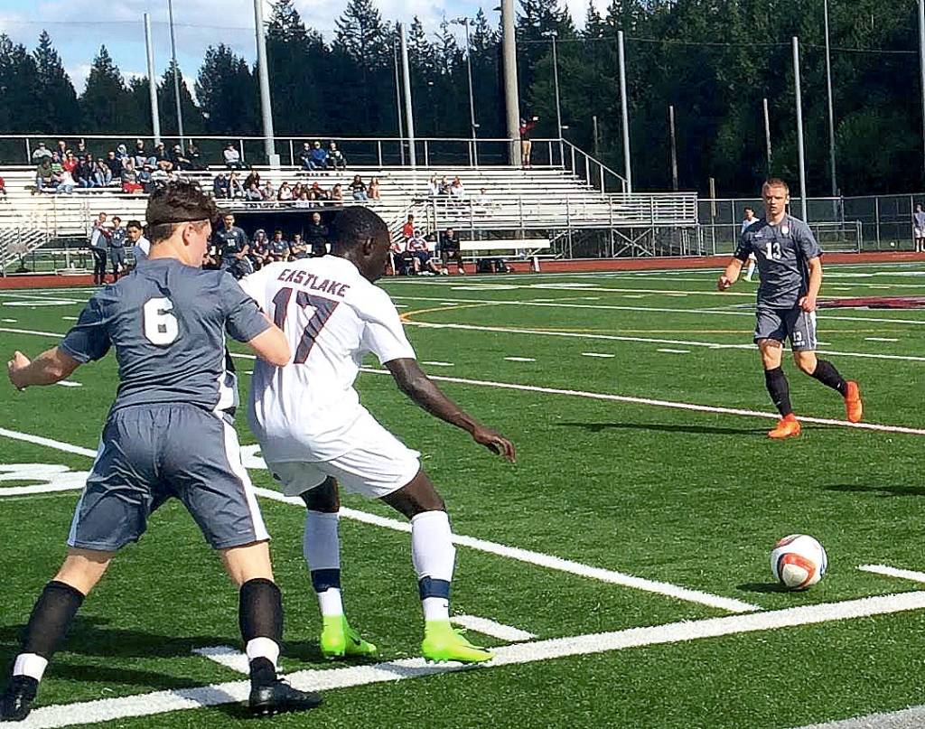 Mount Si defender Mateo Didomenico, left, puts pressure on Eastlake forward Bakary Sey in the first half of play. Eastlake outscored Mount Si 4-3 in an overtime penalty kick shootout to capture the victory in a loser-out playoff game on May 6 at Eastlake High School in Sammamish. (Shaun Scott/Staff Photo)
