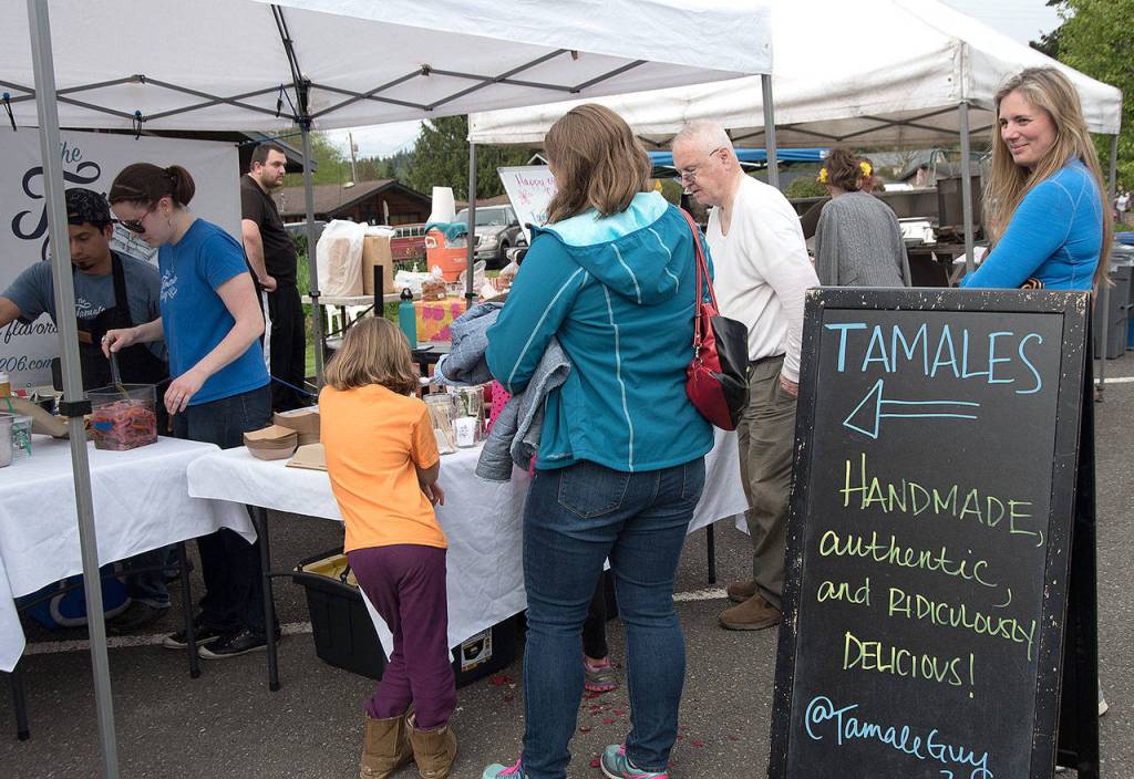 Customers line up for &ldquo;ridiculously delicious&rdquo; tamales on opening day of the market.                                Carol Ladwig/Staff Photo