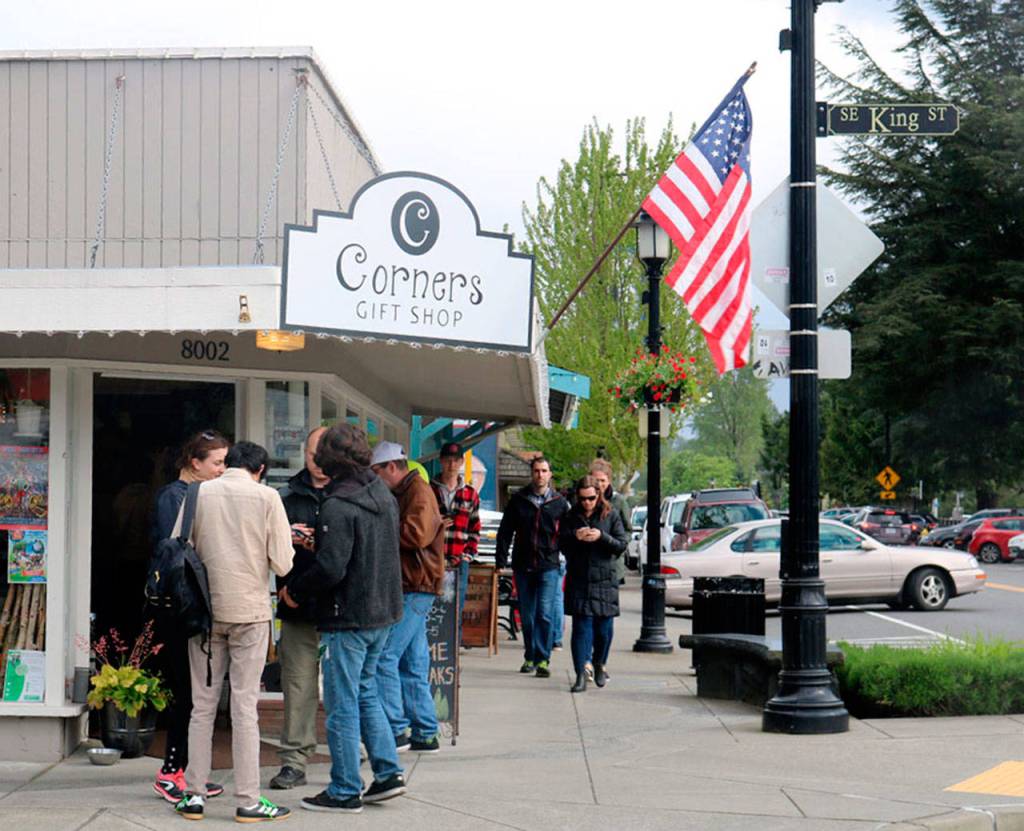 Teams of friends gather in downtown Snoqualmie to determine where to go for the next item on their Twin Peaks scavenger hunt list.                                (Evan Pappas/Staff Photo)