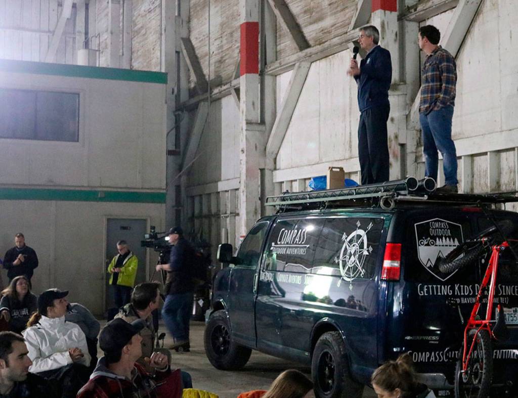 Snoqualmie Mayor Matt Larson and Compass Outdoor Adventure Owner Luke Talbott speak to the crowd before the movie begins and hand out prizes to the winners of the scavenger hunt.                                (Evan Pappas/Staff Photo)