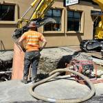 Workers use metal plates to shore up their work area underground earlier this week, as they get ready to repair a stormwater pipe damaged May 4.                                Carol Ladwig/Staff Photo