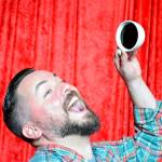 A fan mugs with a fake cup of coffee as part of the Red Room set in Compass Outdoor Adventures.                                (Mary Miller Photo)