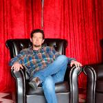 Luke Talbott, owner and CEO of Compass Outdoor Adventures, takes a seat in the red room inside his business.                                (Evan Pappas/Staff Photo)