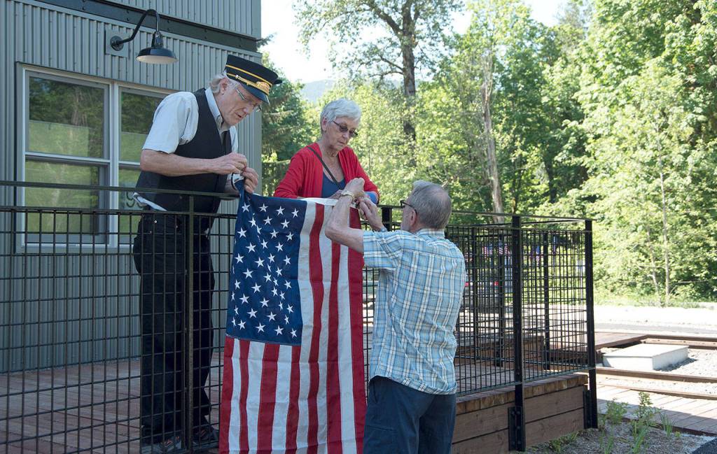 Volunteers Dennis Snook, and Sally and Hugh Hansen decorate the Railway Education Center in preparation for the day&rsquo;s first trainload of visitors to celebrate the museum&rsquo;s 60th anniversary, 50th year of train rides, and 10th anniversary of the creation of the museum&rsquo;s history campus.                                Carol Ladwig/Staff Photo