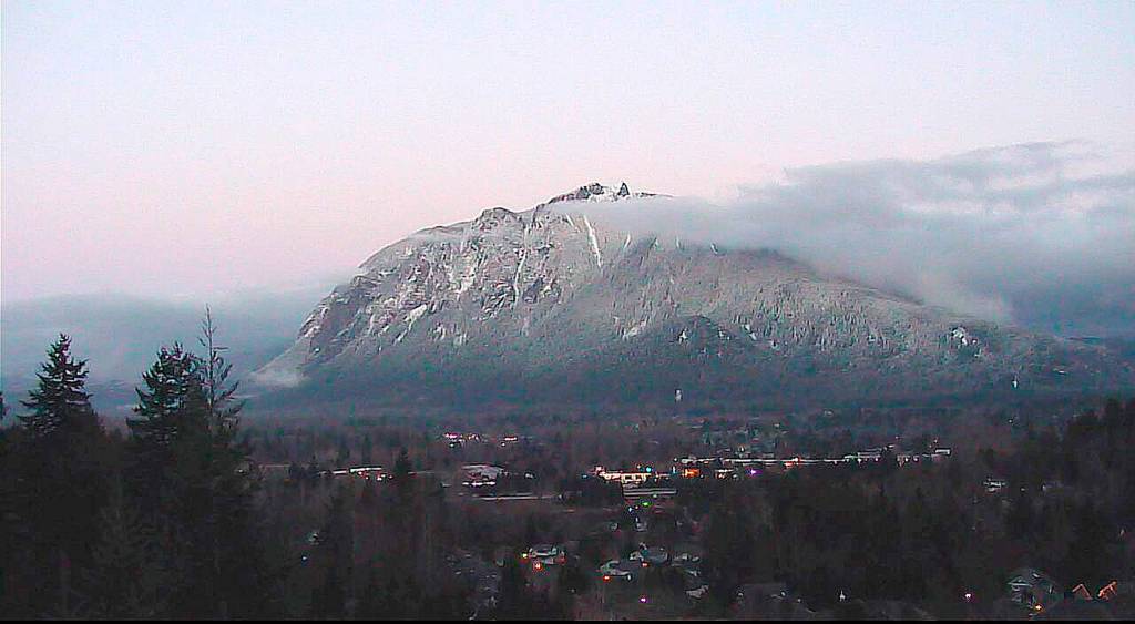 The lights of North Bend create an inviting glow against the cloudy backdrop of the ever-changing Mount Si in this first-place photo in the Valley Record&rsquo;s annual reader photo contest. Credit for this photo goes to North Bend Economic Development Office Coordinator Tom Meagher, via the city&rsquo;s webcam.