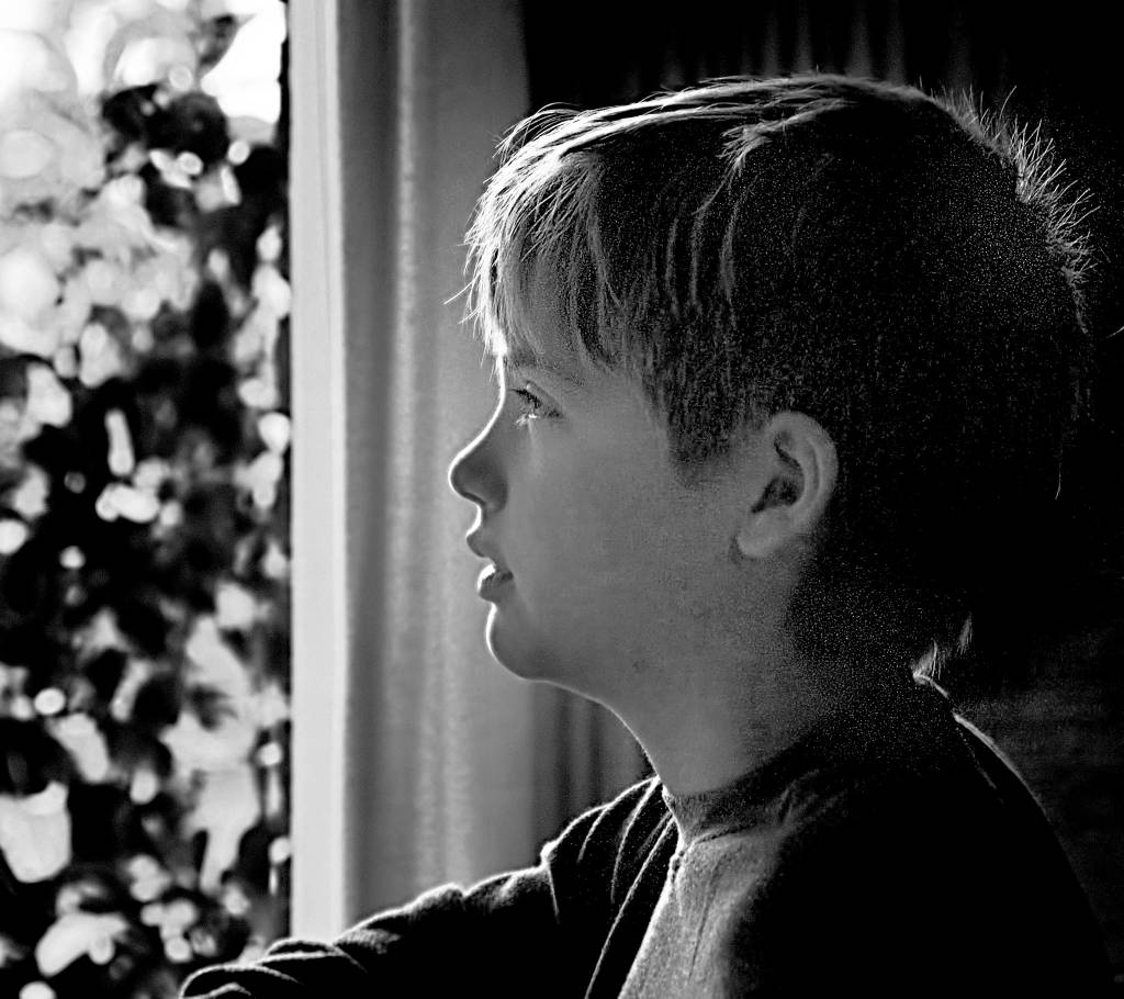 Middle schooler Nathaniel Raphael looks out the window in this first-place People photo by his father, Danny