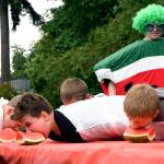 A challenger at the 2016 watermelon-eating contest chases his melon as it slides across the table. The watermelon eating contest starts at 1:30 at Olive Taylor Quigley Park this Saturday.                                File Photo