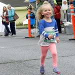 One of the youngest 2016 Fall City Day racers smiles as she heads to the finish line.                                William Shaw/File Photo