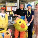 Pitching in to help sell duck derby tickets for the big race down the river Saturday are Chief Kanim Middle School students Harmon Speikers, Jaden Donaldson, and Sam Walker, with Fall City Elementary School teacher Colleen Meyers. Proceeds from the annual race down the river by numbered rubber duckies support the festival and Snoqualmie Valley Schools. Purchase tickets now at Fall City businesses and Saturday at the festival booth. Cost is $5 for one duck, or $20 for five. The Grand Prize is $500 cash; additional prizes are tickets to the Seattle Mariners games, Remlinger Farms, and SeaFair. Race time is 2:30 p.m.                                Courtesy Photo