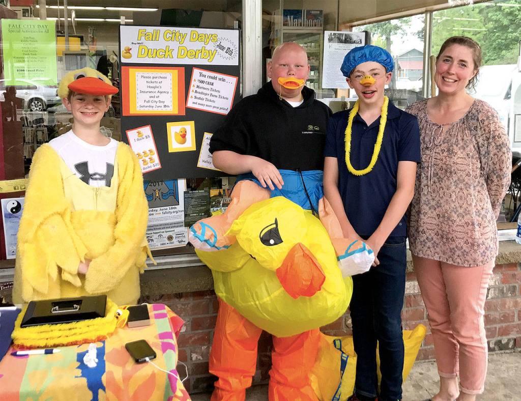 Pitching in to help sell duck derby tickets for the big race down the river Saturday are Chief Kanim Middle School students Harmon Speikers, Jaden Donaldson, and Sam Walker, with Fall City Elementary School teacher Colleen Meyers. Proceeds from the annual race down the river by numbered rubber duckies support the festival and Snoqualmie Valley Schools. Purchase tickets now at Fall City businesses and Saturday at the festival booth. Cost is $5 for one duck, or $20 for five. The Grand Prize is $500 cash; additional prizes are tickets to the Seattle Mariners games, Remlinger Farms, and SeaFair. Race time is 2:30 p.m.                                Courtesy Photo