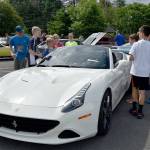 Kids check out a Ferrari at the Mount Si Lions Club car show. (Carol Ladwig/Staff Photo)