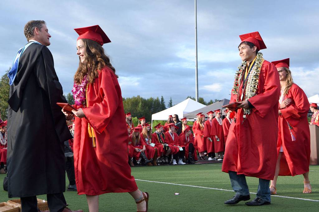 Principal John Belcher congratulates a line of seniors from the Class of 2017.                                Carol Ladwig/Staff Photo