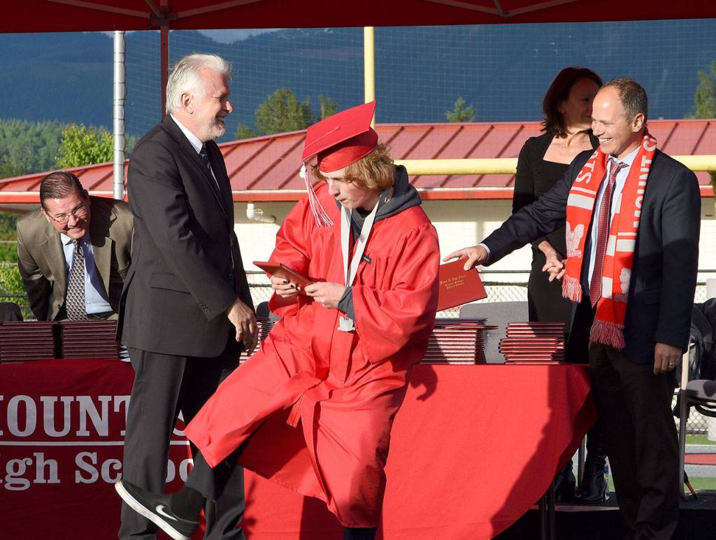 After receiving his diploma, a graduate clicks his heels together.                                Carol Ladwig/Staff Photo