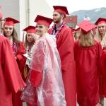 Hunter Dow, swathed in a raincoat, smiles before graduation began Friday night.                                Carol Ladwig/Staff Photo