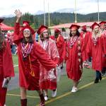 Seniors file into Mount Si Stadium and wave at family members in the audience at Mount Si High School&rsquo;s commencement ceremony Friday.                                Carol Ladwig/Staff Photo