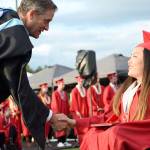 Principal John Belcher congratulates a student who has just received her diploma.                                Carol Ladwig/Staff Photo