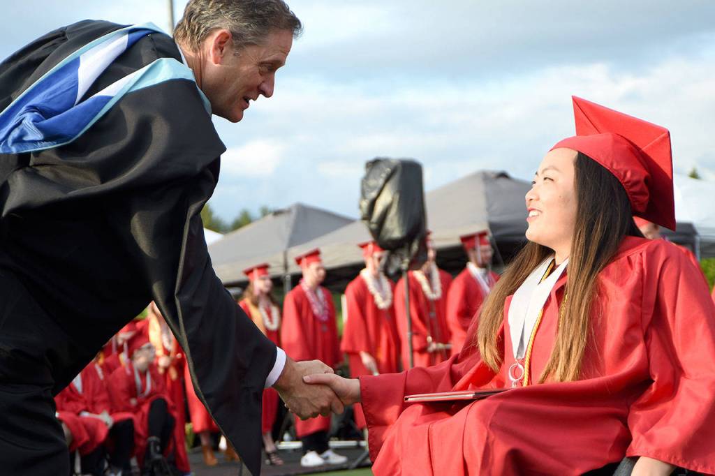 Principal John Belcher congratulates a student who has just received her diploma.                                Carol Ladwig/Staff Photo