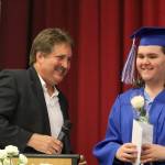 Snoqualmie Valley Rotary representative Steve Weaver presented Aaron Thompson with a $500 scholarship during the graduation ceremony.                                (Evan Pappas/Staff Photo)