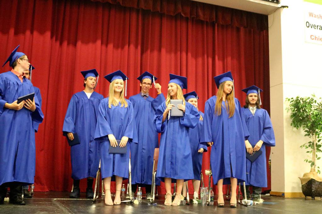 Students walk to the stage and look out into the audience full of family, friends and Two Rivers staff.                                (Evan Pappas/Staff Photo)