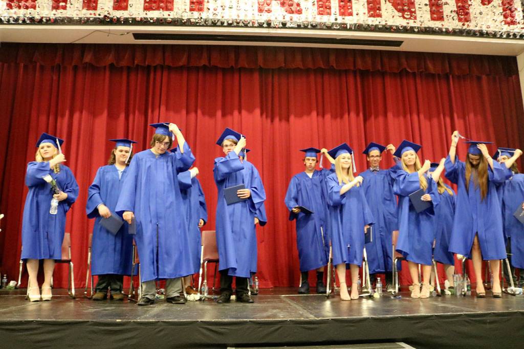 The students all turn their tassels to signify their graduation.                                (Evan Pappas/Staff Photo)
