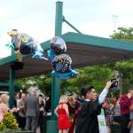 Alex Zarco carries bunch of graduation balloons out of the venue after the ceremony.                                (Evan Pappas/Staff Photo)