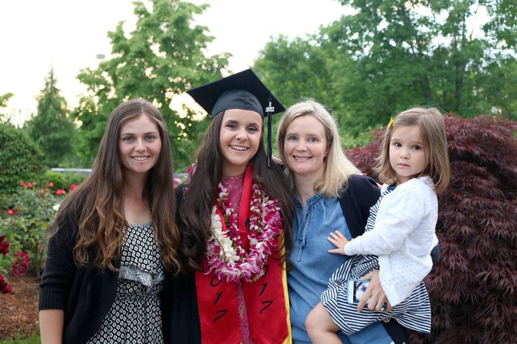 Graduate Morgan Roe poses with Anna Stein, left, and Alex and Brayden Falconi.                                (Evan Pappas/Staff Photo)