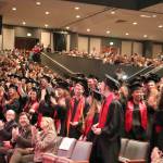 The crowd cheers as the students turn their tassels to mark their graduation.                                (Evan Pappas/Staff Photo)