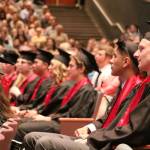 Students are given their diplomas as a camera captures of the ceremony for two projected screens along the sides of the stage.                                (Evan Pappas/Staff Photo)