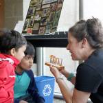 Mihit and Manas Mishra are shown a small exhibit detailing how baby salmon grow at Saturday&rsquo;s summer reading kick-off event at the Snoqualmie Library.                                (Evan Pappas/Staff Photo)